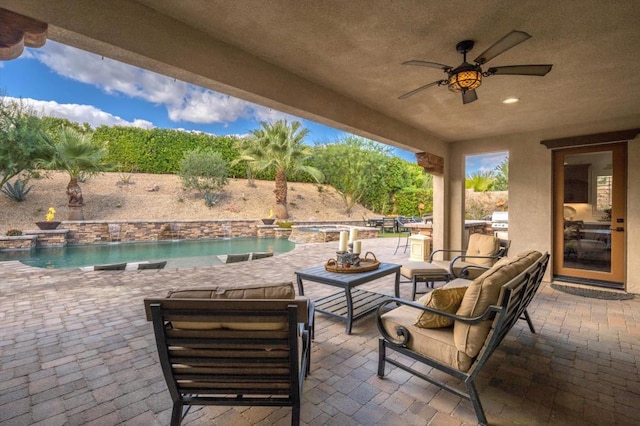 view of patio featuring ceiling fan, a pool with hot tub, and an outdoor hangout area