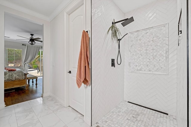 bathroom featuring crown molding, a tile shower, and ceiling fan