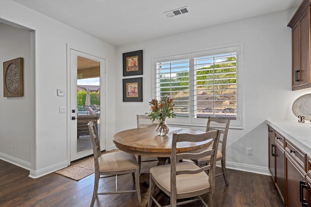 dining space with dark hardwood / wood-style flooring