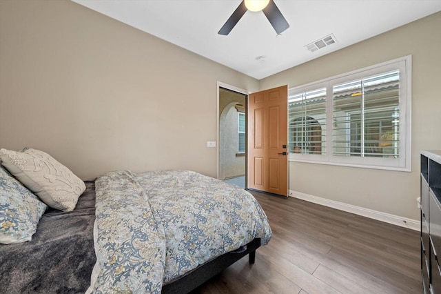 bedroom with ceiling fan and dark hardwood / wood-style flooring