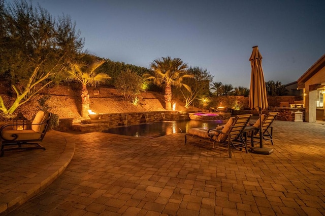 view of patio terrace at dusk