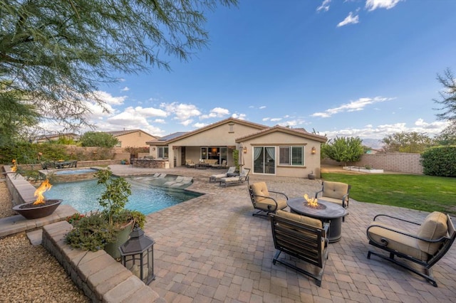 view of swimming pool with a lawn, an outdoor fire pit, and a patio