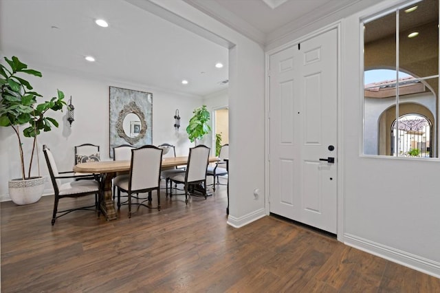 foyer entrance featuring dark wood-type flooring, plenty of natural light, and crown molding