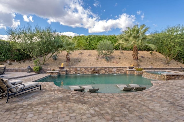 view of pool with an in ground hot tub, pool water feature, and a patio