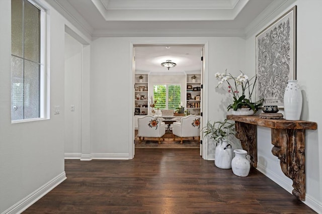 corridor featuring built in features, dark hardwood / wood-style flooring, and ornamental molding