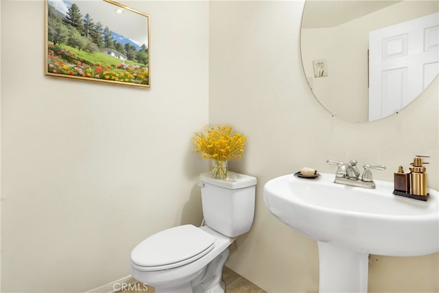 bathroom featuring sink and toilet