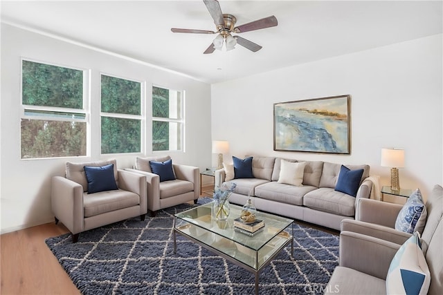 living room featuring ceiling fan and dark hardwood / wood-style flooring