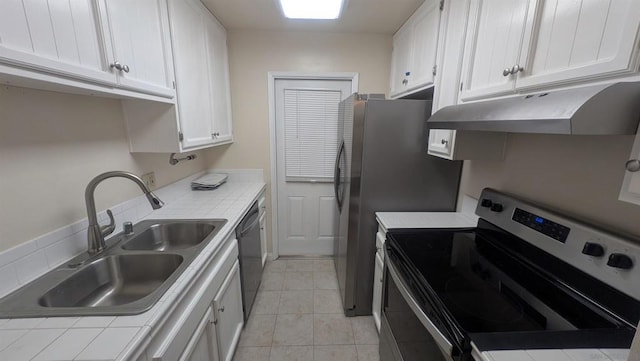 kitchen featuring sink, white cabinets, dishwasher, tile counters, and electric range