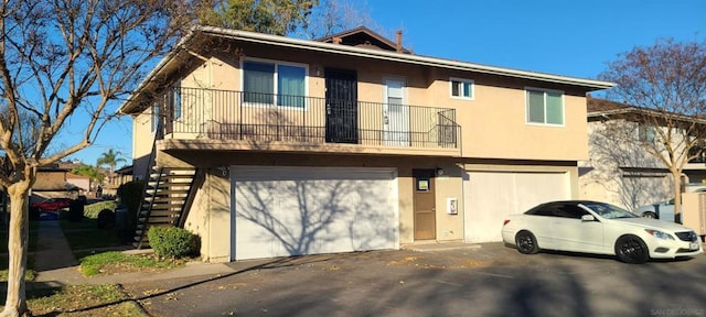 townhome / multi-family property with a balcony and a garage