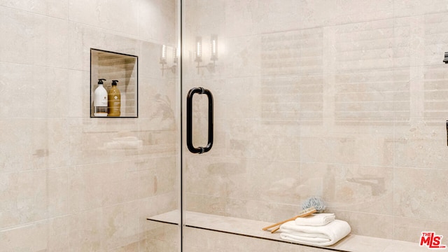 bathroom featuring a shower with door