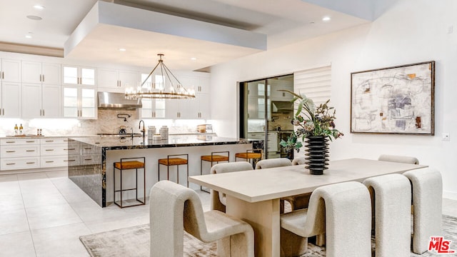 tiled dining space featuring a chandelier