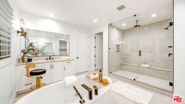 bathroom featuring vanity and plus walk in shower