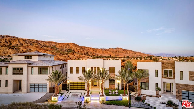 view of property featuring a mountain view and a garage