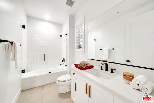 full bathroom featuring toilet, vanity, and tiled shower / bath