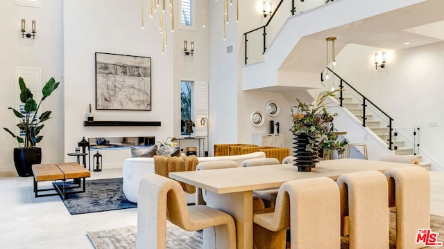 dining space featuring a towering ceiling