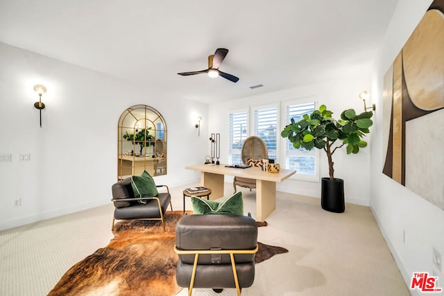 living area featuring light carpet and ceiling fan