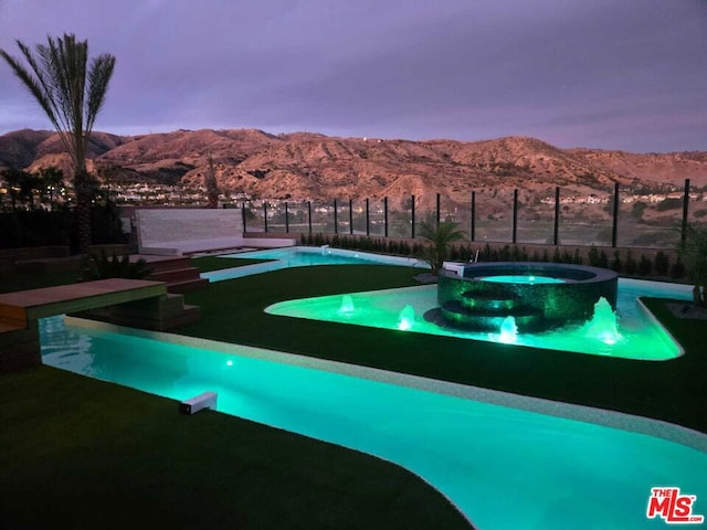 view of home's community featuring a pool and a mountain view