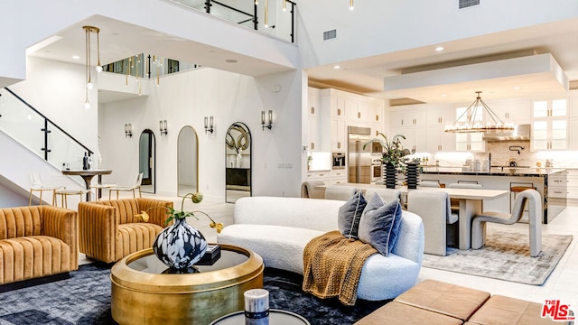 living room with an inviting chandelier and a high ceiling