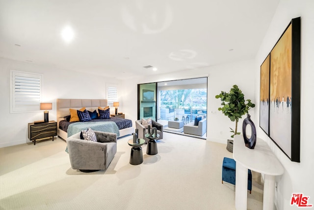 carpeted bedroom featuring multiple windows and access to outside