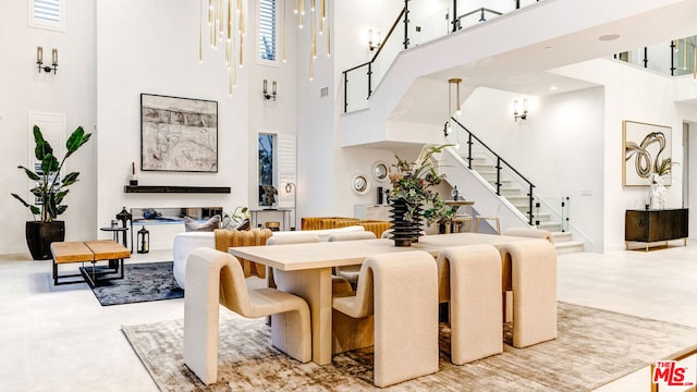 dining area with tile patterned flooring and a high ceiling