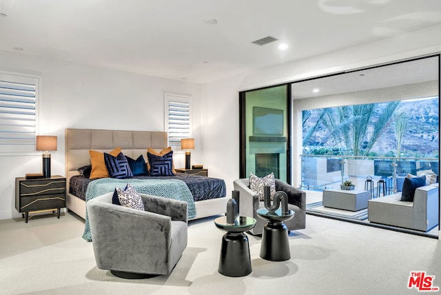 bedroom featuring light colored carpet and access to exterior