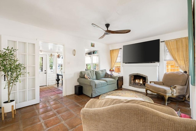 tiled living room featuring a wealth of natural light and ceiling fan