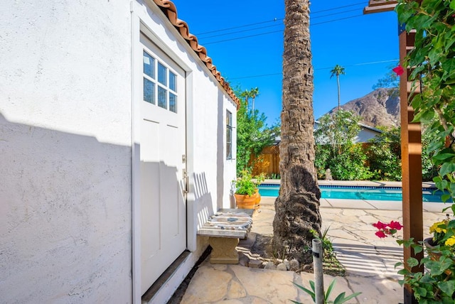 view of patio with a mountain view and a fenced in pool