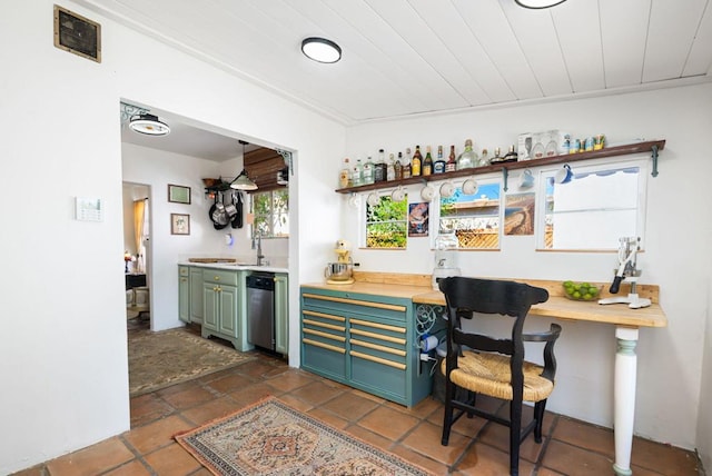 bar featuring green cabinets, crown molding, dishwasher, and sink