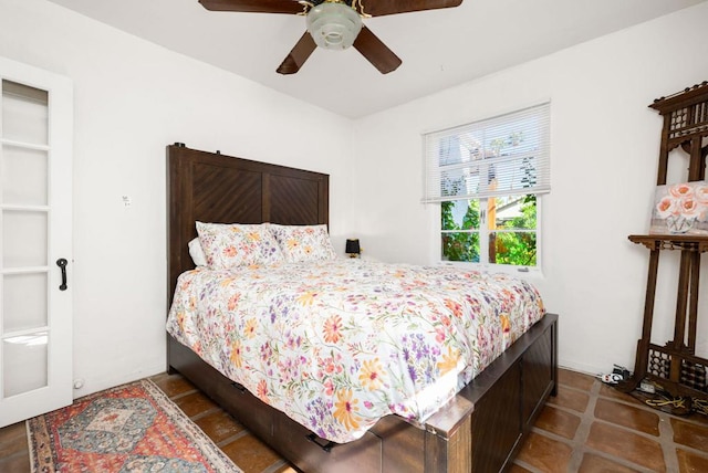 tiled bedroom with ceiling fan