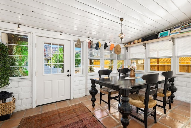 sunroom / solarium featuring vaulted ceiling and wood ceiling