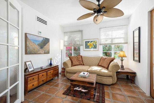 tiled living room with ceiling fan