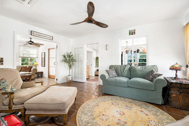 tiled living room featuring ceiling fan