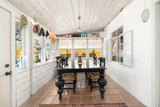 sunroom / solarium with lofted ceiling and wood ceiling