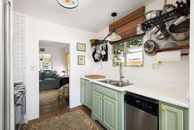 kitchen with green cabinetry, stainless steel appliances, a wealth of natural light, and sink