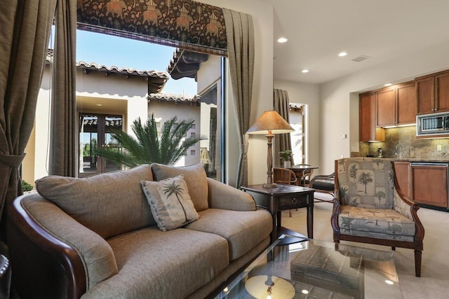 sitting room with light tile patterned floors and a wealth of natural light