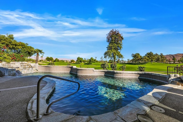 view of pool featuring a yard