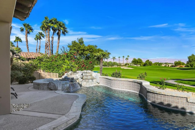 view of pool featuring pool water feature and a lawn