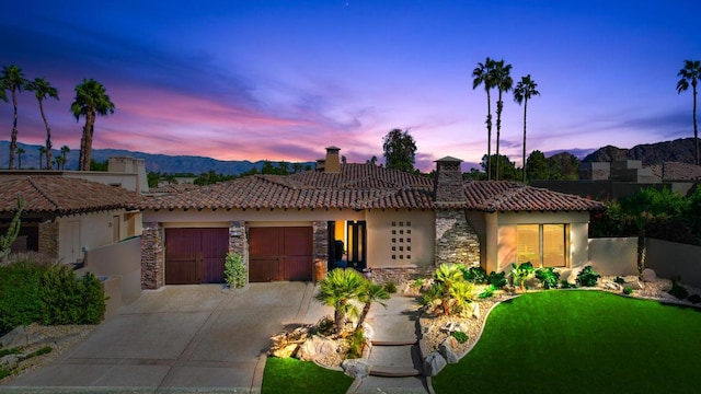 view of front of home featuring a mountain view and a garage