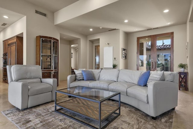 living room with concrete floors and french doors