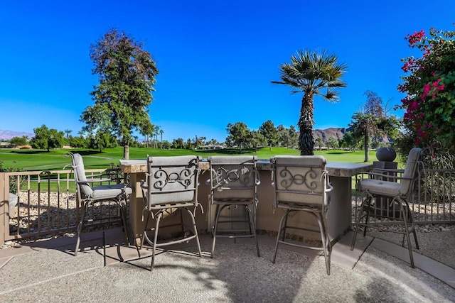 view of patio / terrace featuring a mountain view and exterior bar