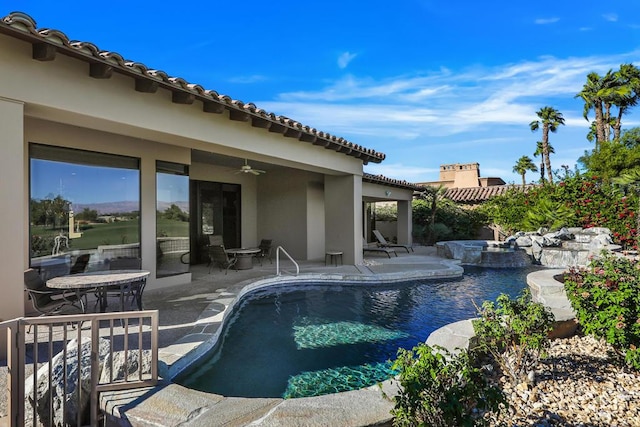 view of pool featuring ceiling fan, a patio, and a jacuzzi