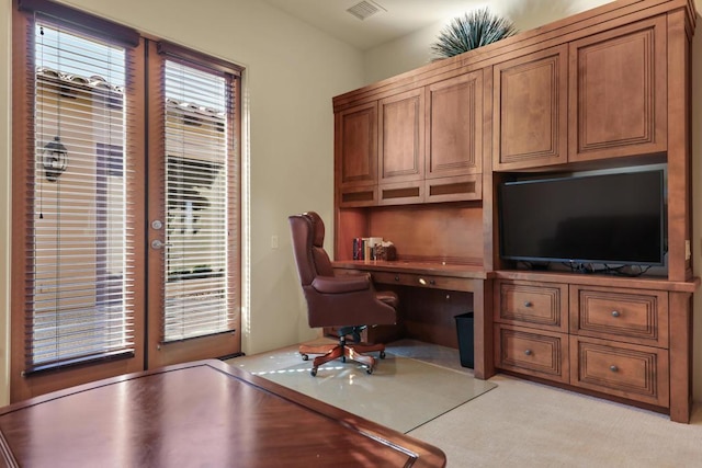 carpeted office featuring built in desk