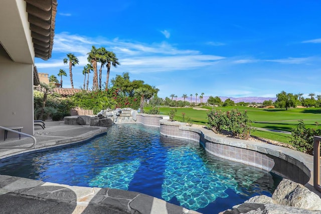 view of swimming pool with a patio area, pool water feature, and a yard