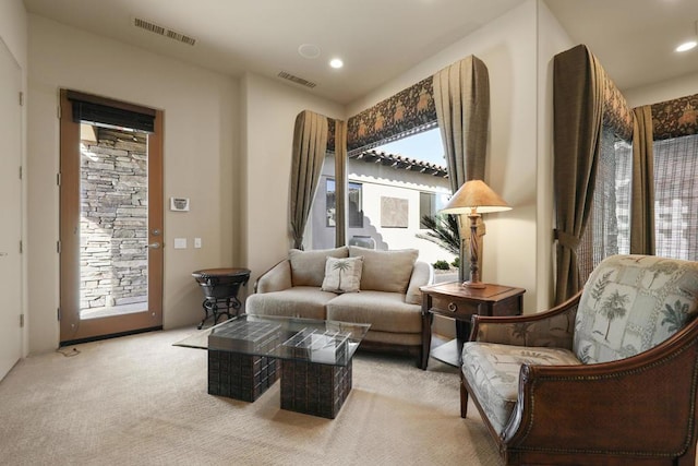 sitting room featuring light colored carpet