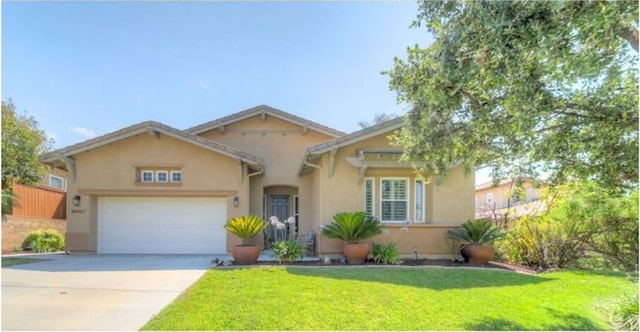 view of front facade featuring a front yard and a garage