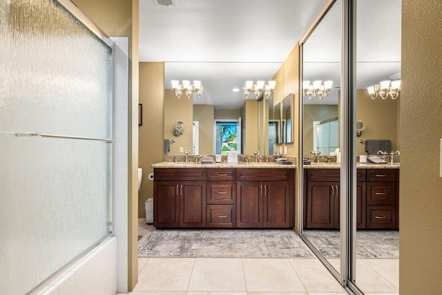 bathroom featuring tile patterned floors, vanity, and a notable chandelier