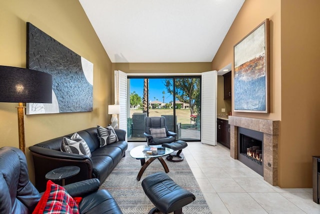 living room featuring high vaulted ceiling, light tile patterned flooring, and a tile fireplace