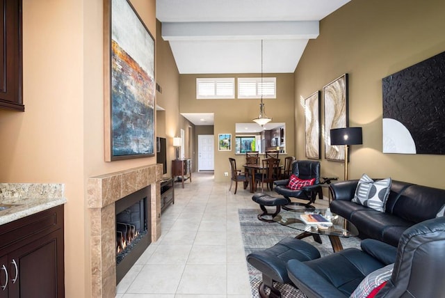 living room with beam ceiling, a high end fireplace, light tile patterned floors, and high vaulted ceiling