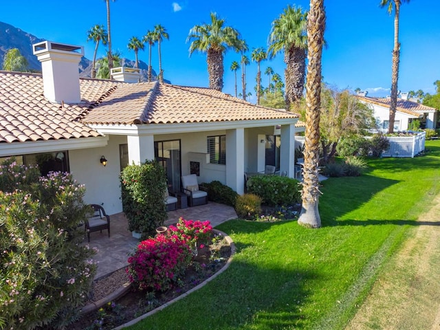 back of house featuring a yard and a patio