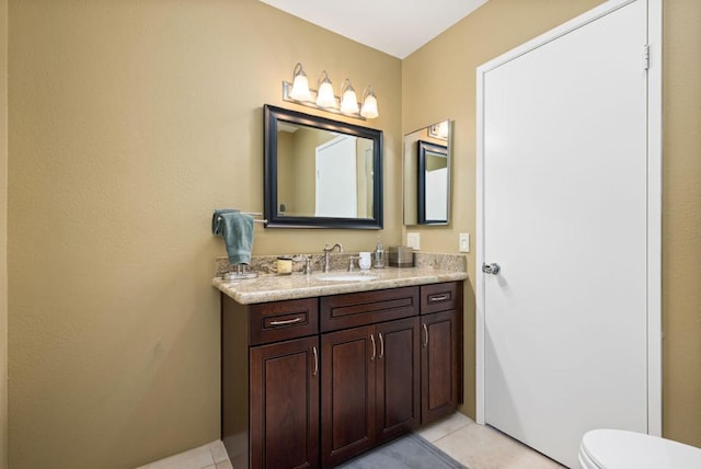 bathroom with tile patterned floors, vanity, and toilet